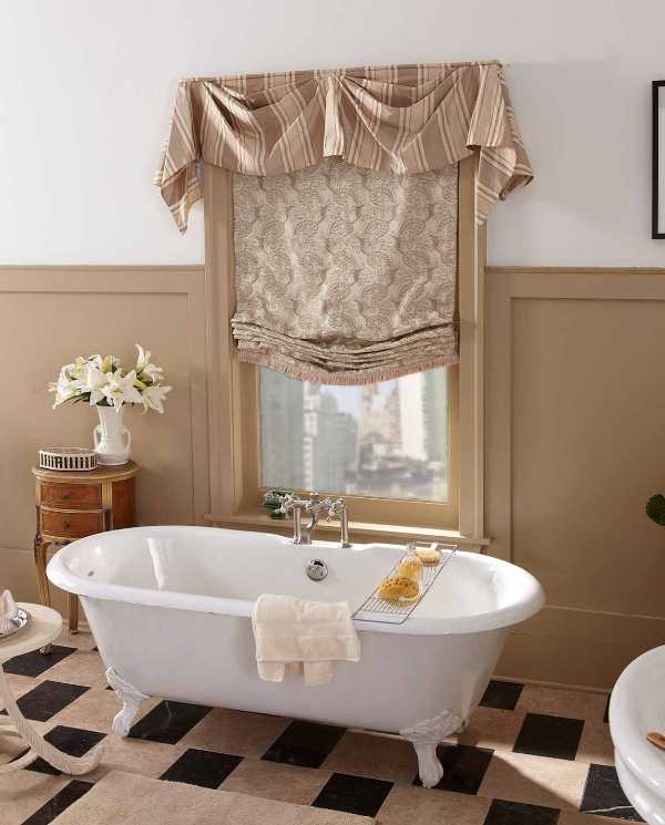 traditional drapery gives privacy to a claw foot tub